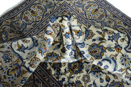 Backside of handmade 2000s Kashan rug showing knot structure and weave density