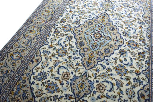 Backside of handmade 2000s Kashan rug showing knot structure and weave density