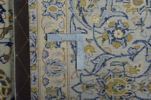 Backside of handmade 2000s Kashan rug showing knot structure and weave density