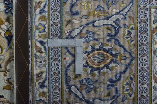 Backside of handmade 2000s Kashan rug showing knot structure and weave density