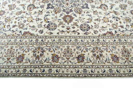 Corner detail of 2000s Kashan rug showing border pattern and Wool pile