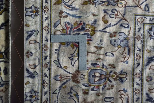 Backside of handmade 2000s Kashan rug showing knot structure and weave density