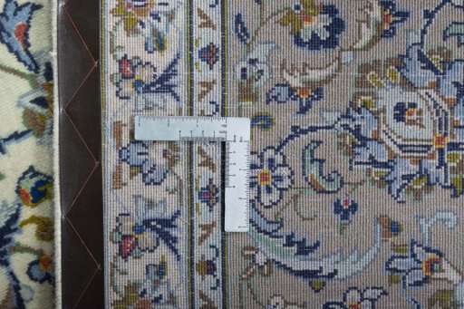 Backside of handmade 2000s Kashan rug showing knot structure and weave density