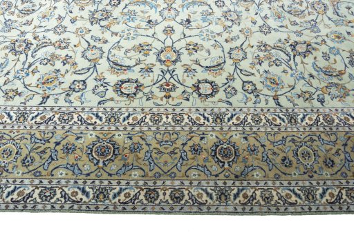 Corner detail of 2000s Kashan rug showing border pattern and Wool pile