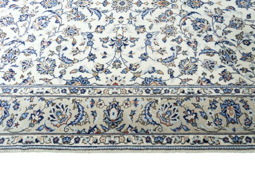 Corner detail of 2000s Kashan rug showing border pattern and Wool pile