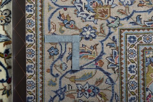 Backside of handmade New Kashan rug showing knot structure and weave density