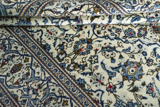 Corner detail of 2000s Kashan rug showing border pattern and Wool pile