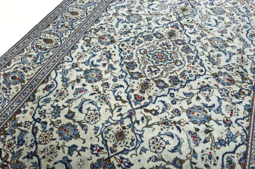 Backside of handmade 2000s Kashan rug showing knot structure and weave density