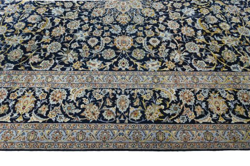 Corner detail of 2000s Kashan rug showing border pattern and Wool pile