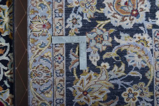 Backside of handmade 2000s Kashan rug showing knot structure and weave density