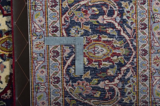 Backside of handmade New Kashan rug showing knot structure and weave density