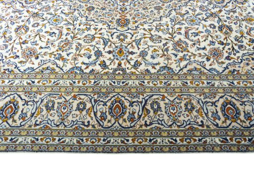Corner detail of 2000s Kashan rug showing border pattern and Wool pile