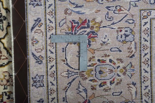 Backside of handmade 2000s Kashan rug showing knot structure and weave density