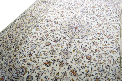 Backside of handmade 2000s Kashan rug showing knot structure and weave density