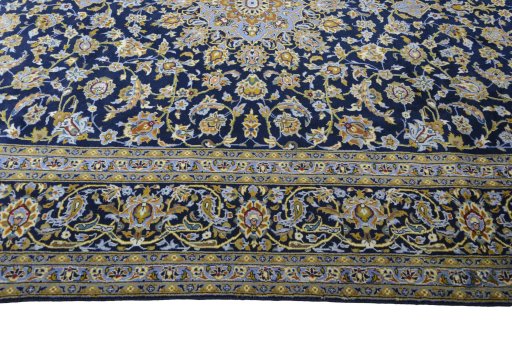 Corner detail of 2000s Kashan rug showing border pattern and Wool pile