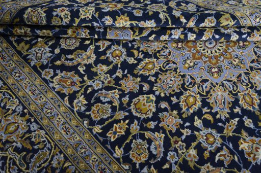 Close-up detail of 2000s Kashan rug from Iran / Persia showing Wool weave