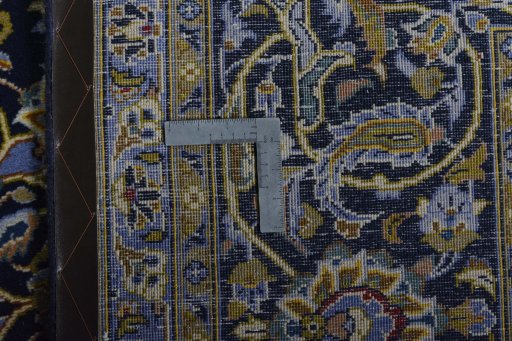 Backside of handmade 2000s Kashan rug showing knot structure and weave density