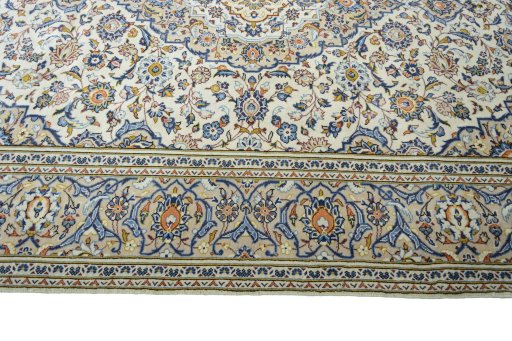 Corner detail of 2000s Kashan rug showing border pattern and Wool pile