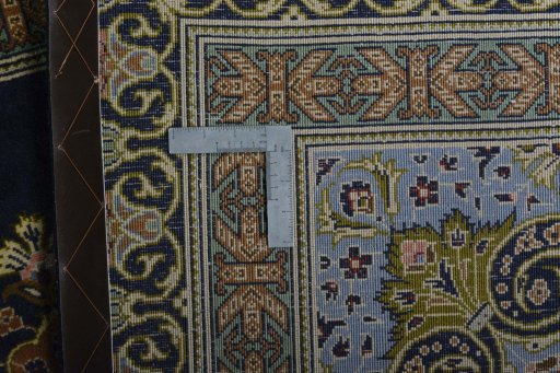 Backside of handmade 2000s Kashan rug showing knot structure and weave density