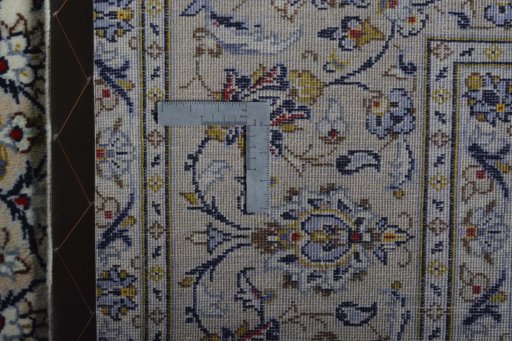 Backside of handmade 2000s Kashan rug showing knot structure and weave density