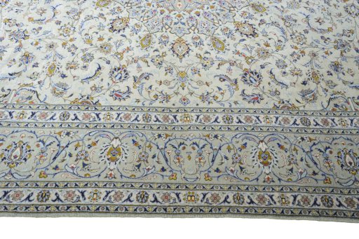 Corner detail of 2000s Kashan rug showing border pattern and Wool pile