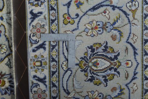 Backside of handmade 2000s Kashan rug showing knot structure and weave density