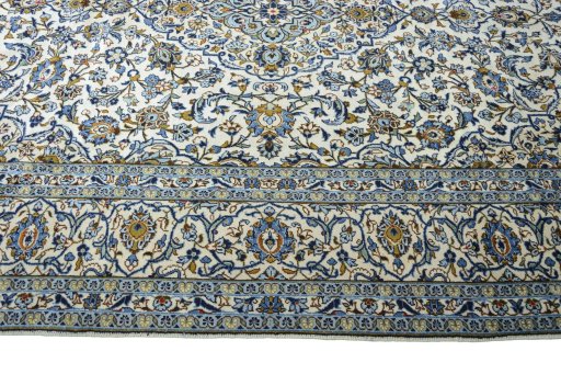 Corner detail of 2000s Kashan rug showing border pattern and Wool pile