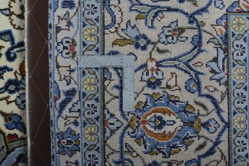 Backside of handmade 2000s Kashan rug showing knot structure and weave density