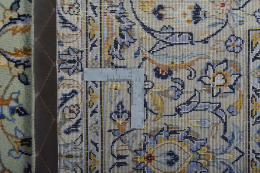 Backside of handmade 2000s Kashan rug showing knot structure and weave density
