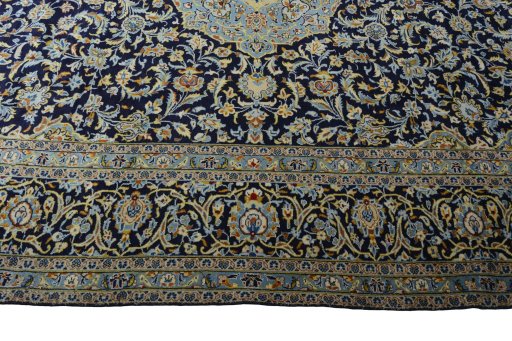 Corner detail of 2000s Kashan rug showing border pattern and Wool pile