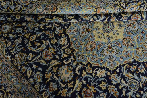 Close-up detail of 2000s Kashan rug from Iran / Persia showing Wool weave