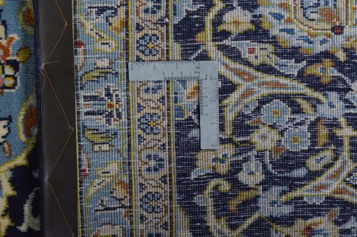 Backside of handmade 2000s Kashan rug showing knot structure and weave density