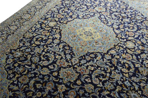 Backside of handmade 2000s Kashan rug showing knot structure and weave density