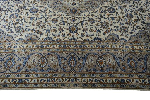 Corner detail of 2000s Kashan rug showing border pattern and Wool pile
