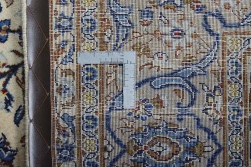 Backside of handmade 2000s Kashan rug showing knot structure and weave density