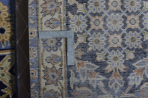 Backside of handmade 2000s Kashan rug showing knot structure and weave density
