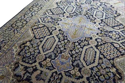 Backside of handmade 2000s Kashan rug showing knot structure and weave density