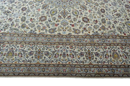 Corner detail of 2000s Kashan rug showing border pattern and Wool pile