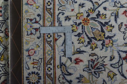 Backside of handmade 2000s Kashan rug showing knot structure and weave density