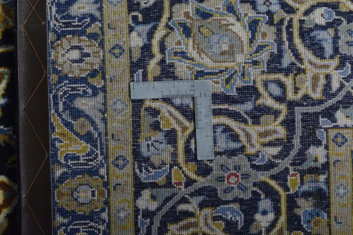 Backside of handmade 2000s Kashan rug showing knot structure and weave density
