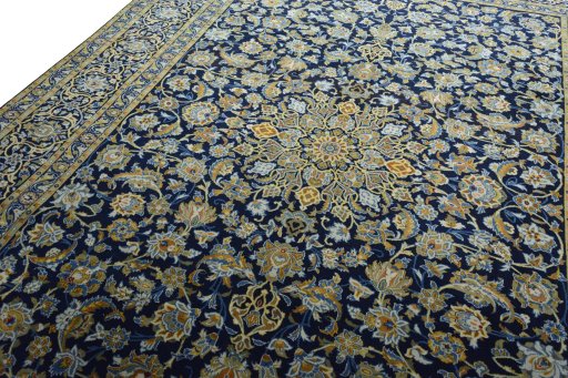 Backside of handmade 2000s Kashan rug showing knot structure and weave density