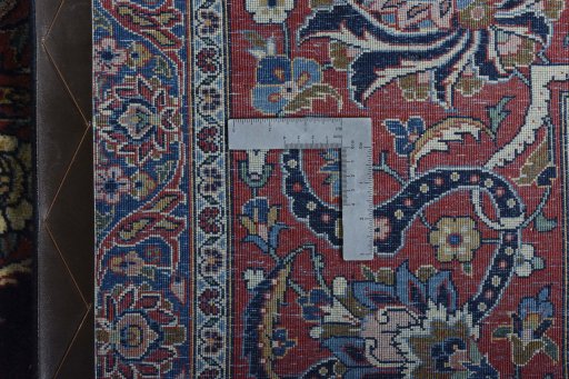 Backside of handmade 1930s Kashan rug showing knot structure and weave density