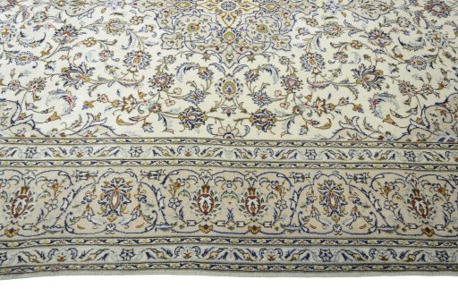 Corner detail of 2000s Kashan rug showing border pattern and Wool pile