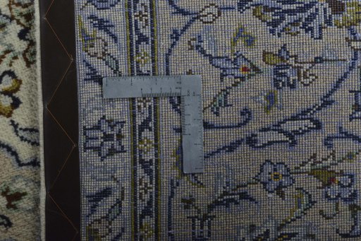 Backside of handmade 2000s Kashan rug showing knot structure and weave density