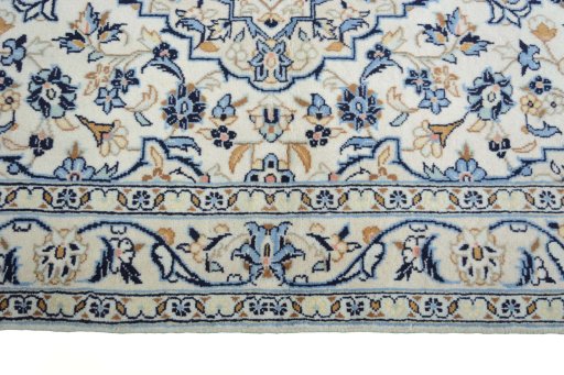 Corner detail of New Kashan rug showing border pattern and Wool pile