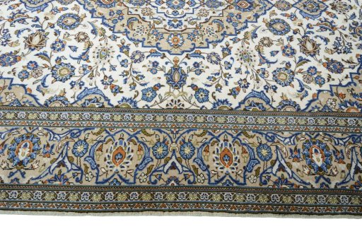 Corner detail of 2000s Kashan rug showing border pattern and Wool pile