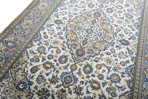 Backside of handmade 2000s Kashan rug showing knot structure and weave density