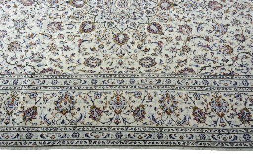 Corner detail of 2000s Kashan rug showing border pattern and Wool pile