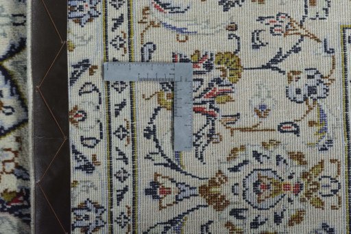 Backside of handmade 2000s Kashan rug showing knot structure and weave density