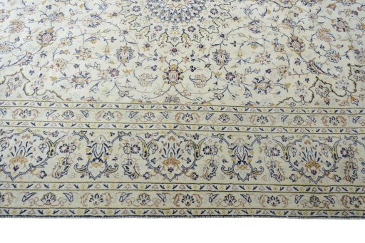 Corner detail of 2000s Kashan rug showing border pattern and Wool pile